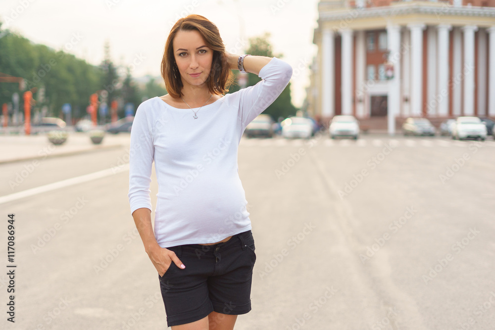 Pregnant woman standing in the square