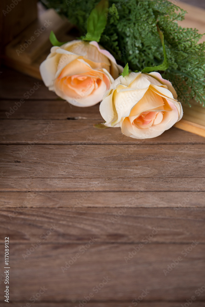 Fototapeta premium pastel roses on vintage wood background, free copy space