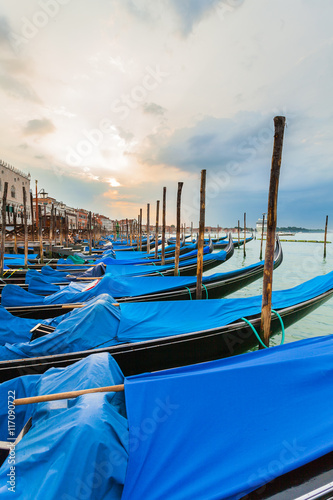 Pier gondolas near Piazza San Marco in Venice at sunrise. A number of boats on the background of the waterfront in Venice. Italy © LALSSTOCK