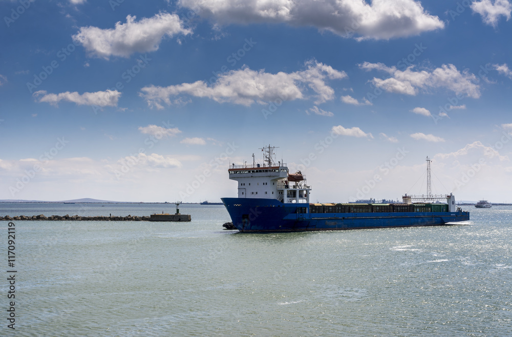 Cargo Ship and Tugboat. Seascape with beautiful sky.
