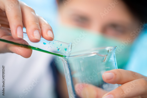 Student girl in chemical klassroom with test tubes