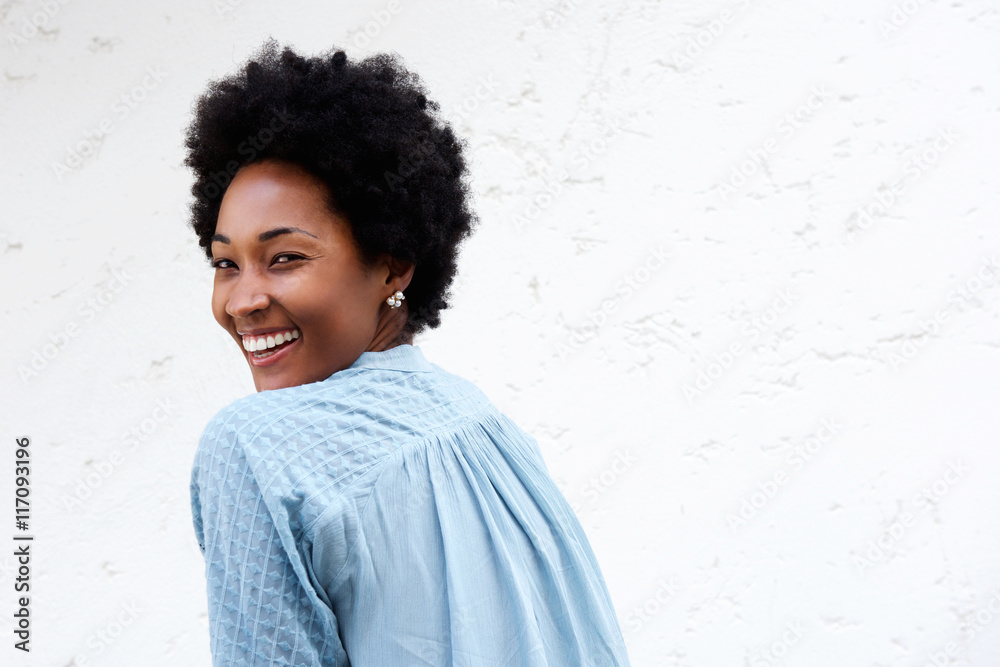 Smiling young african lady looking back Smiling young african lady looking back