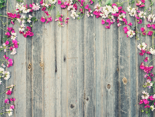 Field flowers pink and white on vintage weathered wooden background