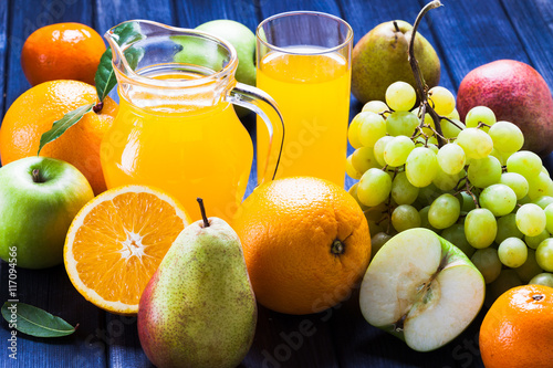Fototapeta Naklejka Na Ścianę i Meble -  Fruit and juice still life, jug, glass, grape, pear, Apple, oranges