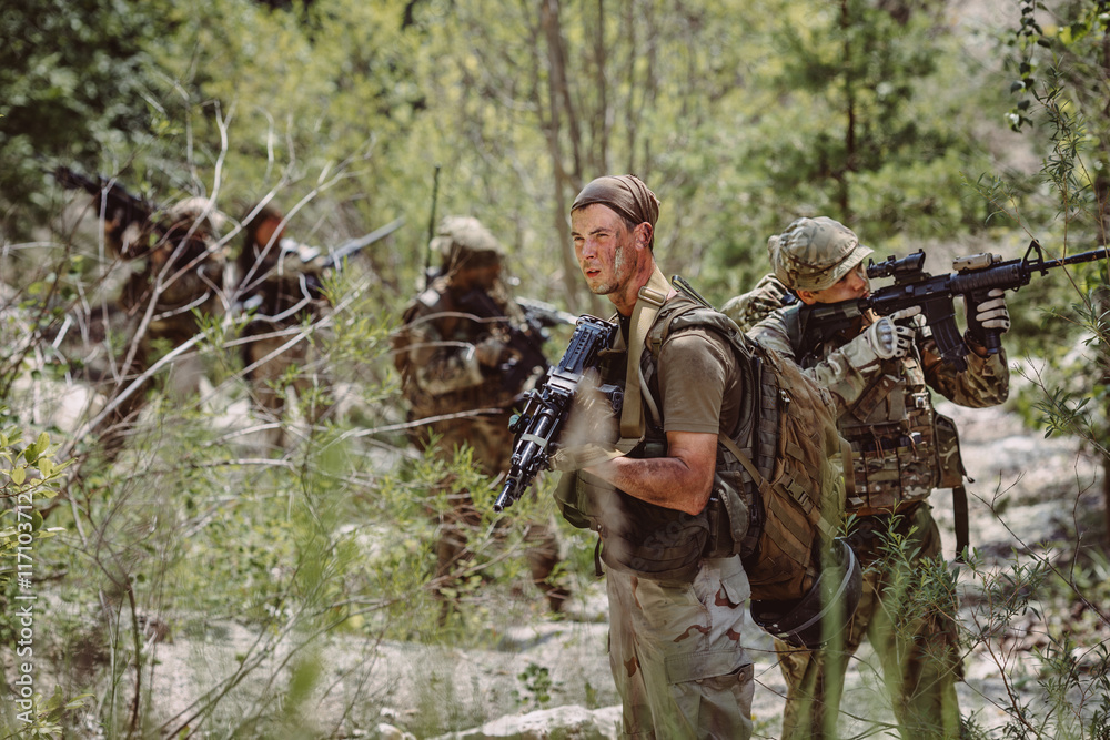 Fototapeta premium Special forces soldiers with weapon take part in military maneuv