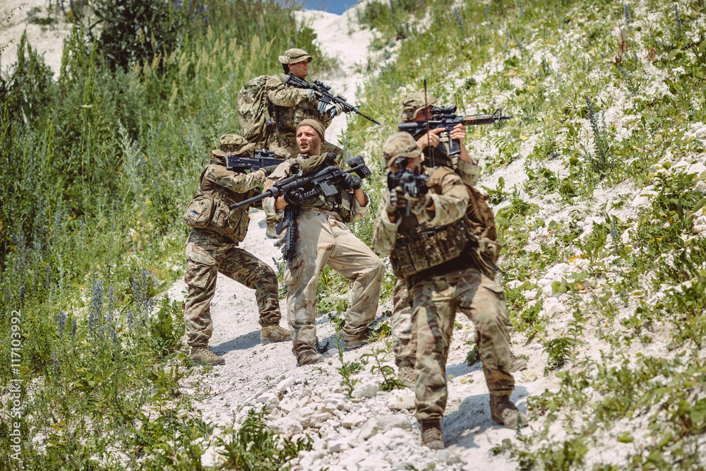 Special forces soldiers with weapon take part in military maneuv Special forces soldiers with weapon take part in military maneuv