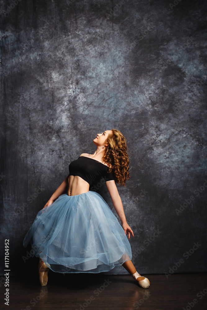 beautiful and delicate ballerina in a studio on gray background beautiful and delicate ballerina in a studio on gray background
