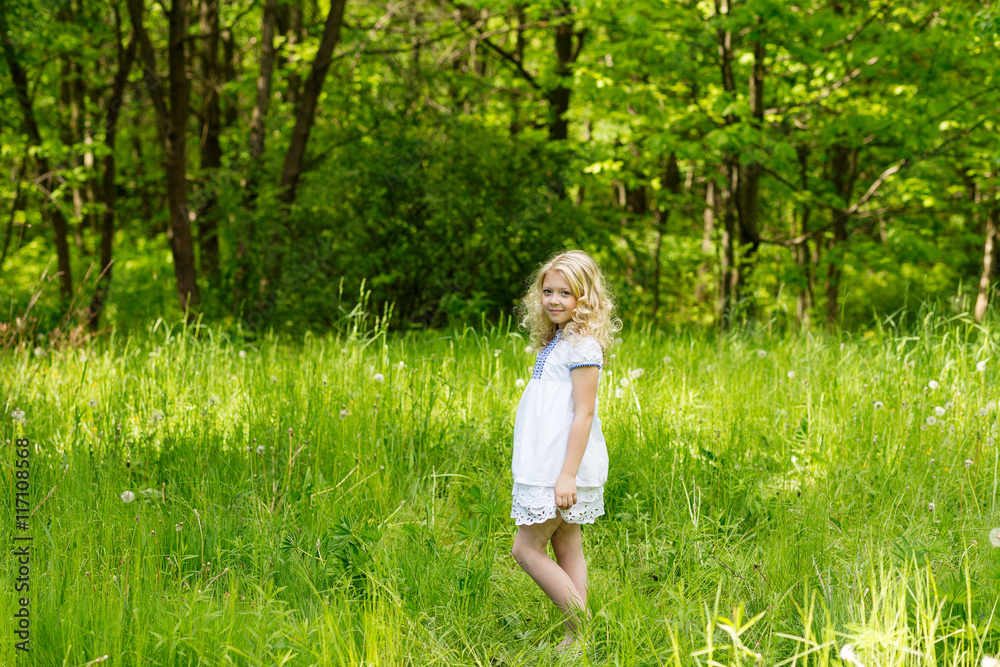 Portrait cute blonde girl outdoors in summer