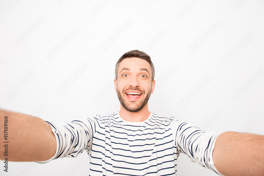 Happy cheerful handsome man making funny selfie Happy cheerful handsome man making funny selfie