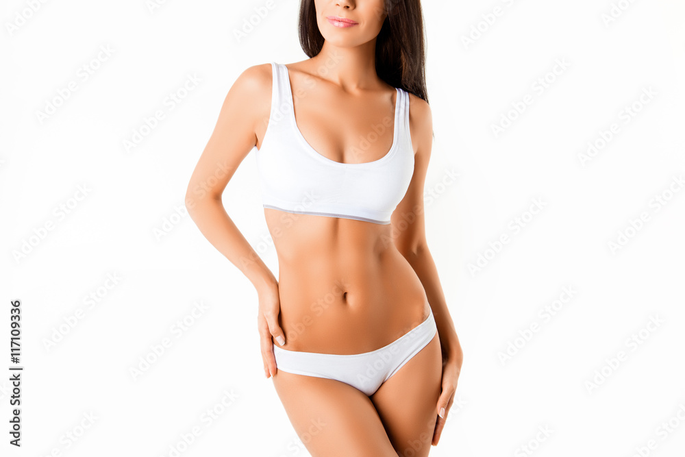 Muscular woman's body in lingerie isolated on white background Muscular woman's body in lingerie isolated on white background