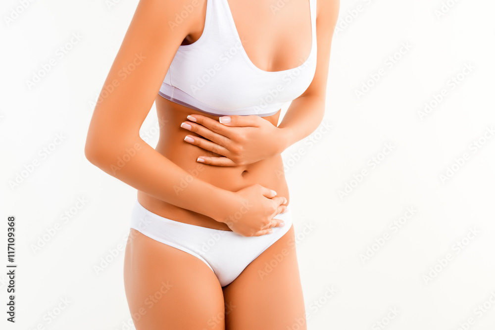 Close up of woman having abdominal pain or menstrual cramps Close up of woman having abdominal pain or menstrual cramps