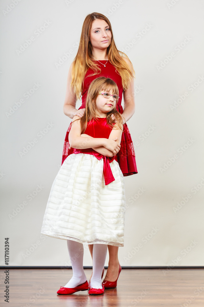 Mother and daughter posing together