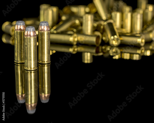 Fotografering Samll brass pistol ammunition and reflection