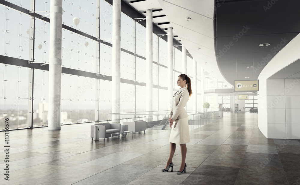 Fototapeta premium Businesswoman in modern office interior . Mixed media