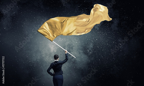 Fotografie, Obraz Woman waving yellow flag . Mixed media