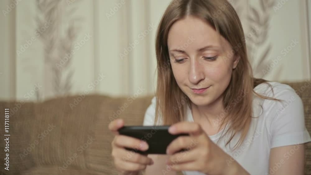 Woman typing text messages on smart phone at home, closeup shot Woman typing text messages on smart phone at home, closeup shot
