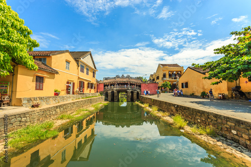 Ancient Vietnamese city of Hoi An. River in the city center. The background is a historic landmark Japanese Bridge. Hoi An, Vietnam