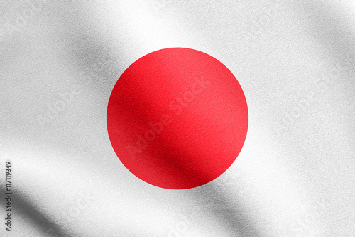 Flag of Japan waving in wind with fabric texture