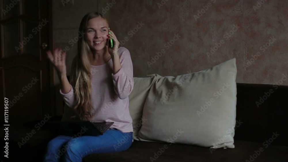 woman sitting at sofa and using laptop woman sitting at sofa and using laptop