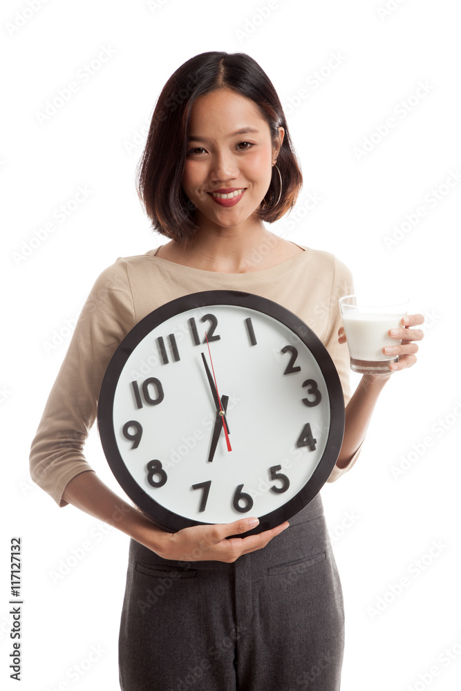 Healthy Asian woman drinking glass of milk hold clock Healthy Asian woman drinking glass of milk hold clock