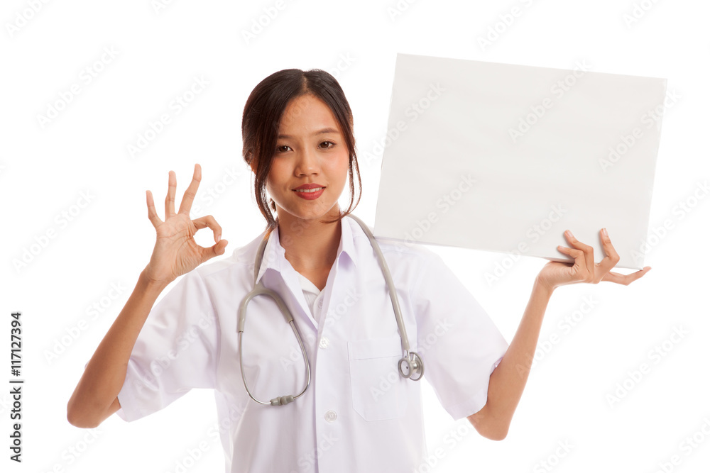 Young Asian female doctor show a blank sign and OK sign Young Asian female doctor show a blank sign and OK sign
