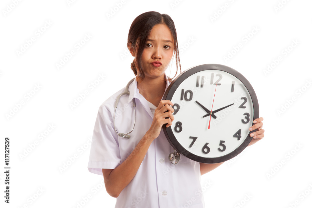 Frustrated Young Asian female doctor with a clock Frustrated Young Asian female doctor with a clock