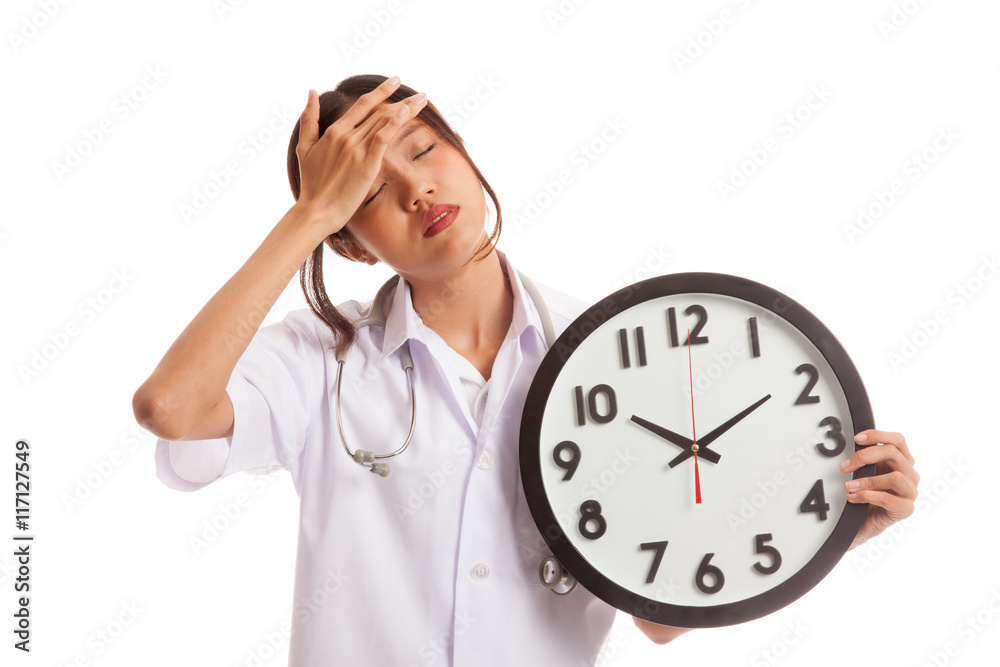 Young Asian female doctor headache with a clock Young Asian female doctor headache with a clock