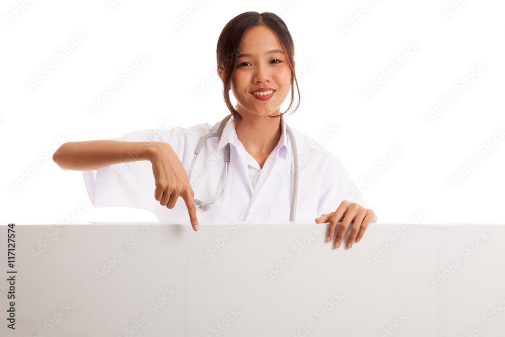 Young Asian female doctor point down to blank sign Young Asian female doctor point down to blank sign