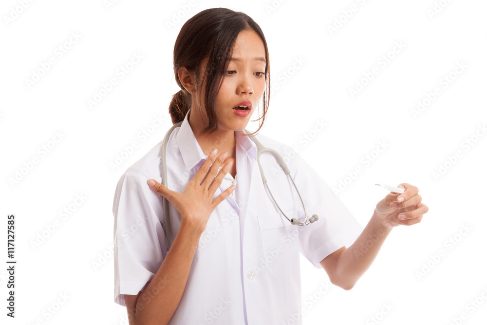 Young Asian female doctor worry look at thermometer Young Asian female doctor worry look at thermometer