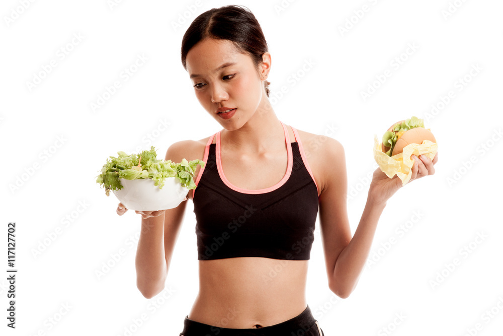 Beautiful Asian healthy girl with salad and hamburger Beautiful Asian healthy girl with salad and hamburger