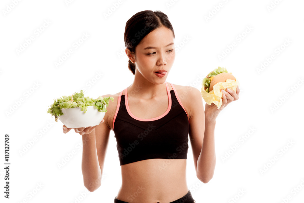 Beautiful Asian healthy girl with salad and hamburger Beautiful Asian healthy girl with salad and hamburger