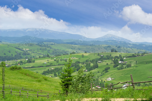 Mountain landscape with farmhouses on the background of mountain