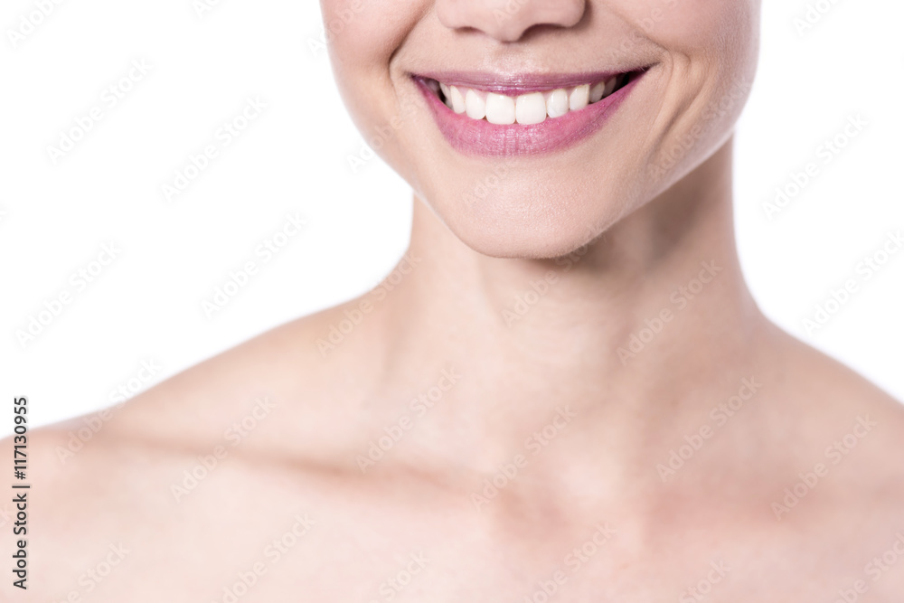 Smiling woman, cropped image. Closeup shot. Smiling woman, cropped image. Closeup shot.