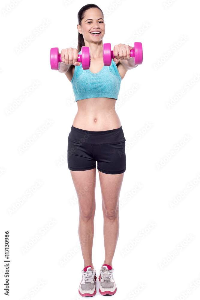Woman doing exercise with dumbbells, studio shot. Woman doing exercise with dumbbells, studio shot.