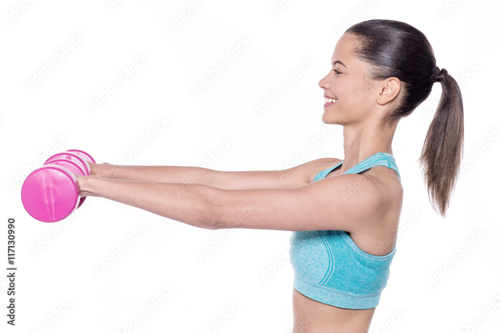 Pretty female trainer exercising with dumbbells Pretty female trainer exercising with dumbbells