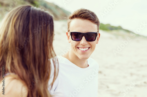 Romantic young couple sitting on the beach