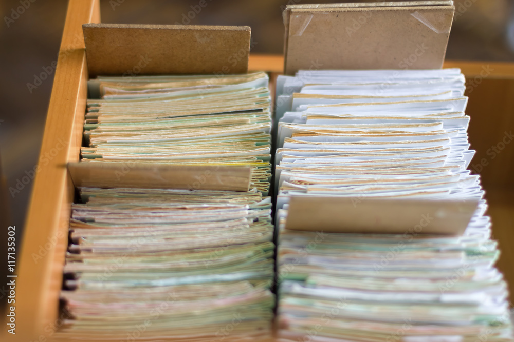 Fototapeta premium File folders in a file cabinet, card catalog in a library, close