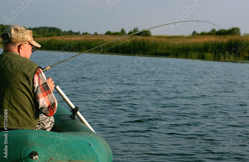 Spinning fisherman on a boat fishing