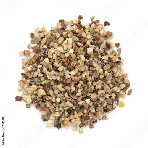 Organic Black pepper (Piper nigrum) peppercorn in big cut size. Isolated on white background. Macro close up. Top view.