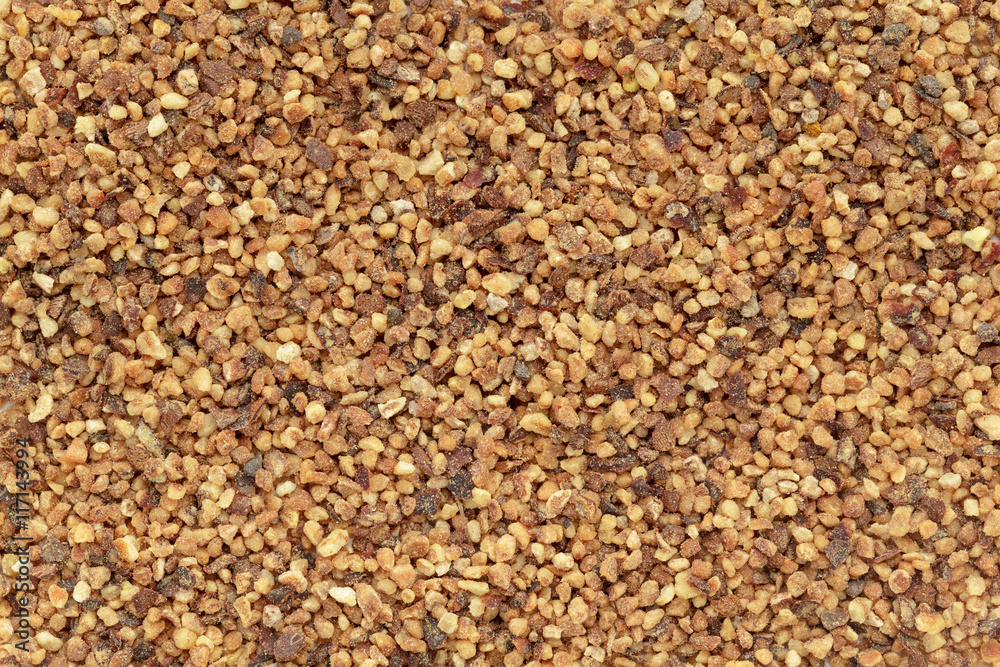 Organic Nutmeg (Myristica fragrans) in tea cut size. Macro close up background texture. Top view. Organic Nutmeg (Myristica fragrans) in tea cut size. Macro close up background texture. Top view.