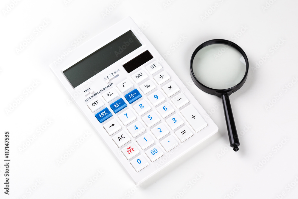 Calculator with a magnifying glass on a white background Calculator with a magnifying glass on a white background