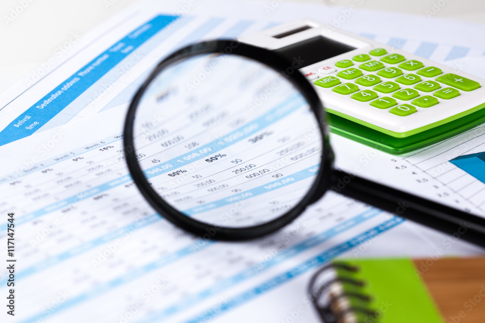 work with a magnifying glass, a calculator and papers work with a magnifying glass, a calculator and papers