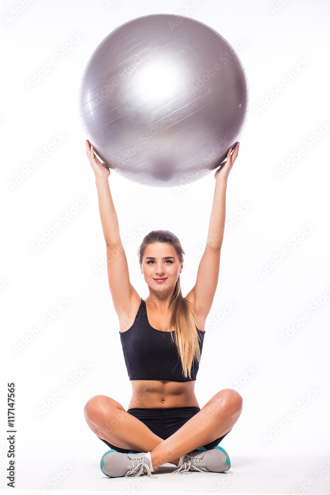 Woman making exercise with pilates ball, against white background Woman making exercise with pilates ball, against white background