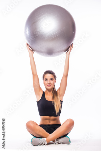 Woman making exercise with pilates ball, against white background