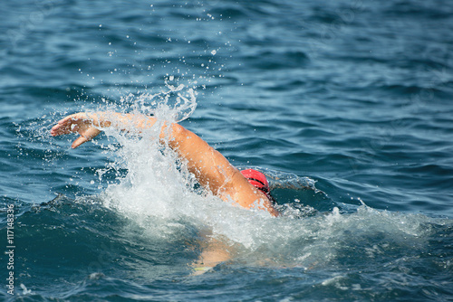 Man swimmer swimming crawl in blue sea