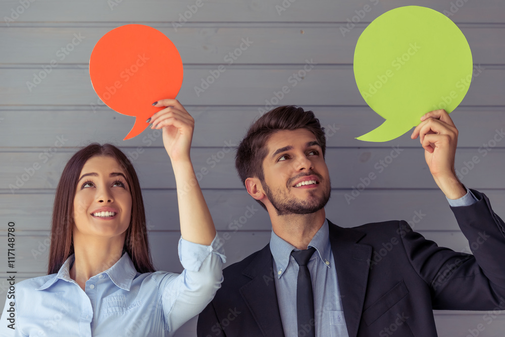 Beautiful business couple with speech bubbles Beautiful business couple with speech bubbles