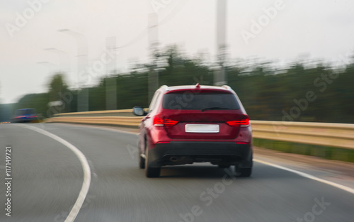 car rides on the highway in cloudy summer day © alexx_60