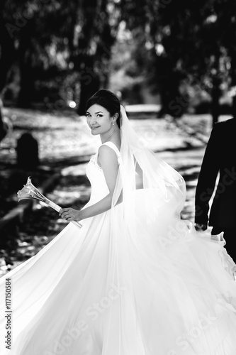 A black and white picture of happy whirling bride