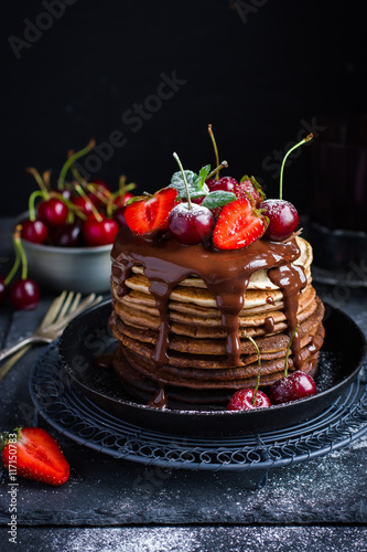 Fotografija Ombre chocolate pancakes with fresh berries and chocolate sauce