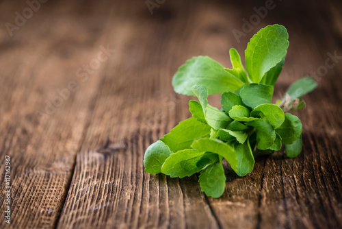 Wooden table with Stevia leaves (selective focus)